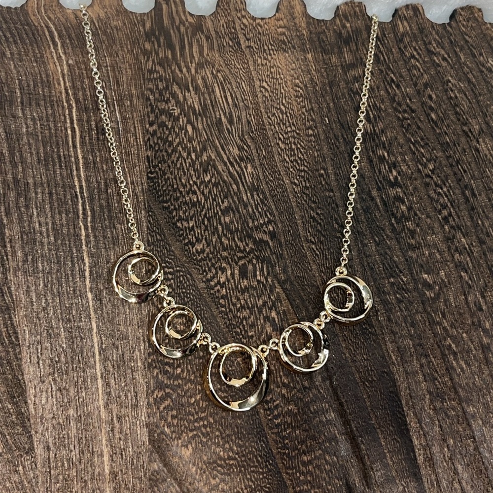 Gold costume necklace with swirls